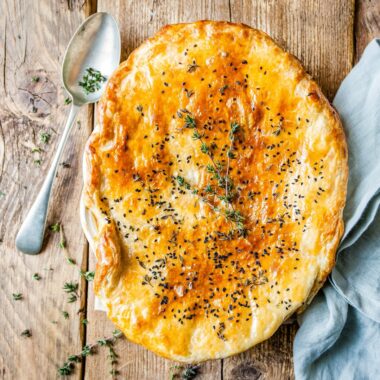 The BEST Easy Chicken Pot Pie in the world. It has a creamy filling, tender chicken, herbs and vegetables and it's all baked under a golden puff pastry lid!