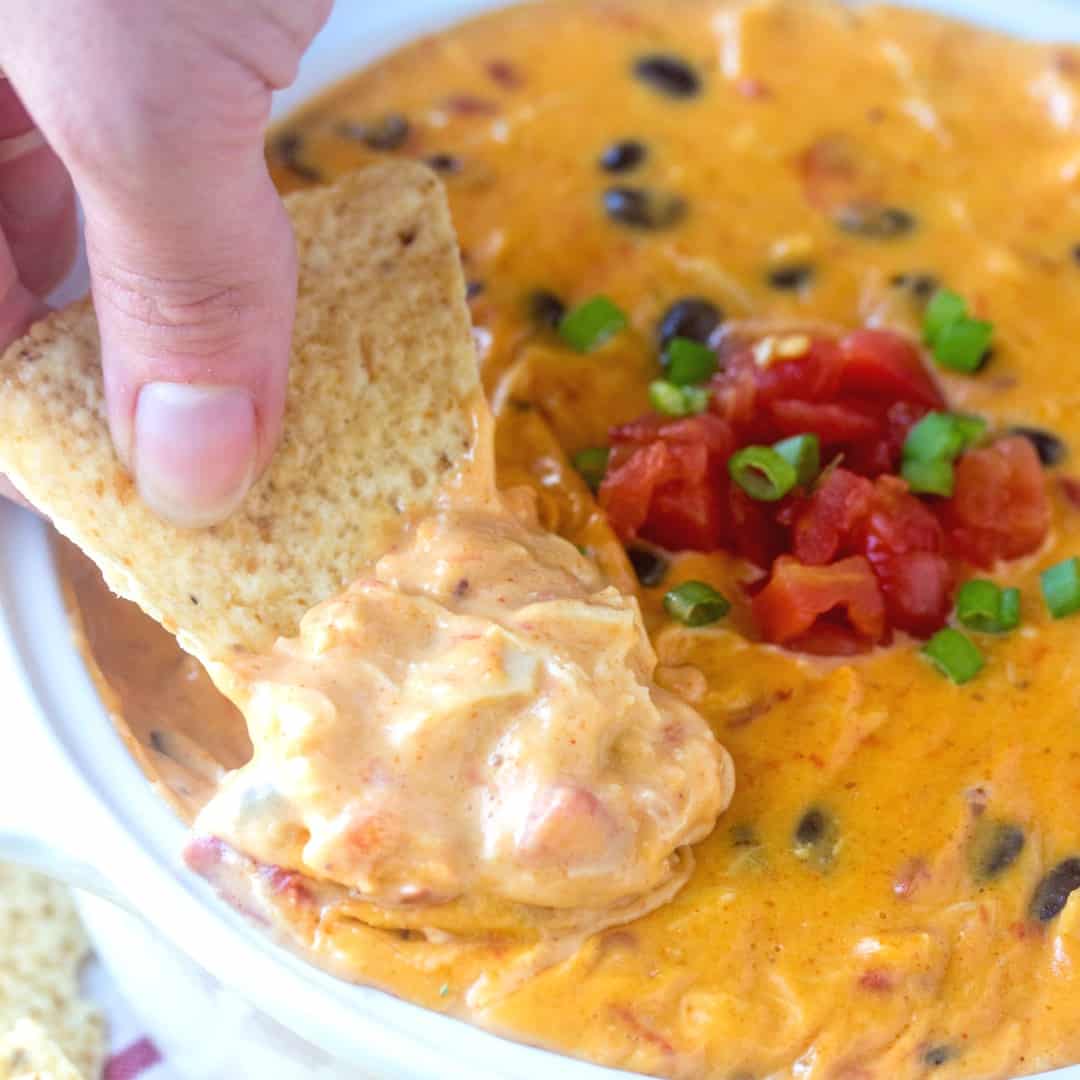 Cheesy, creamy and slightly spicy this Easy Chicken Queso Dip is a fast and tasty appetizer for game day, game night, parties and more! It needs to be on your must make list this year!