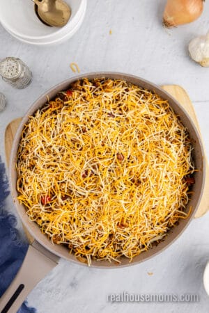 shredded cheese sprinkled over chili mac skillet dinner