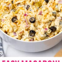 macaroni salad with olives and pickles in a serving bowl with recipe name at the bottom