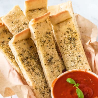 Pizza Dough Breadsticks is so simple to make and just as delicious as your local pizzeria! Make quick and easy breadsticks any night of the week!