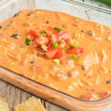 square image of queso chicken dip in a glass pan