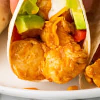 hand holding an easy ranch chicken tacos with recipe name at the bottom