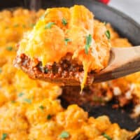 square image of a spoonful of sloppy joe casserole over a skillet