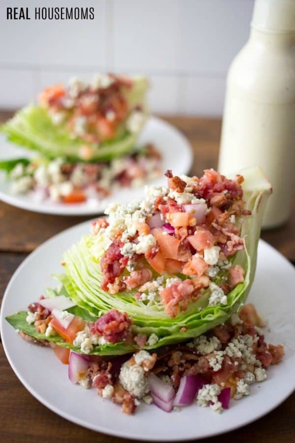 wedge salad served on a plate with dressing bottle