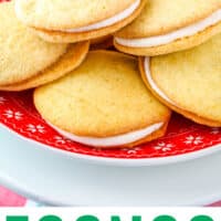 red plate of eggnog whoopie pies on a cake stand with recipe name at bottom