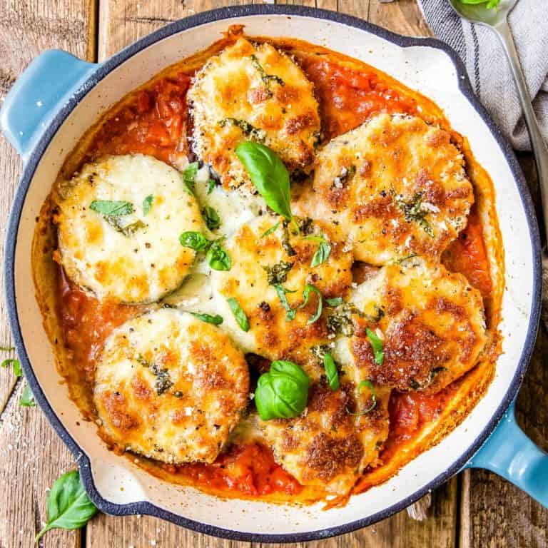 Easy Eggplant Parmesan is the perfect easy dinner. Healthy eggplant is snuggled into a garlic tomato sauce and baked with golden, bubbling cheese!