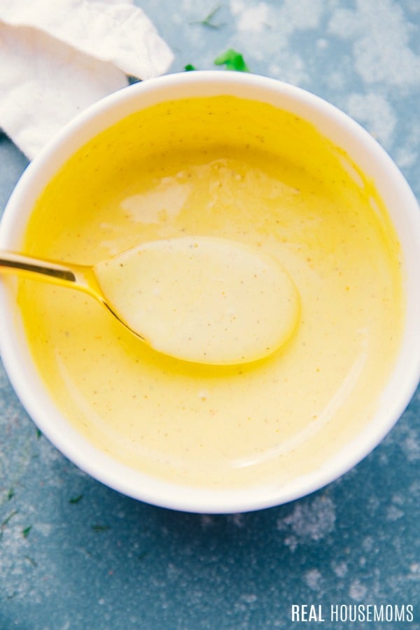 hollandaise sauce in a bowl with a spoon