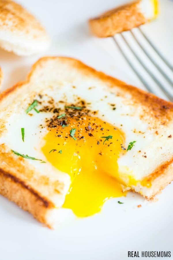 eggs in a basket cut open with yolk running out