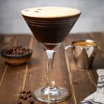 square image of an espresso martini next to some espresso beans