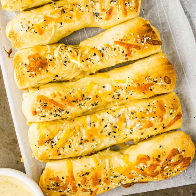 square image of Everything But The Bagel Pigs In A Blankets on a baking sheet