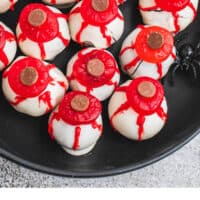 eyeball oreo balls on a black plate with recipe name at he bottom