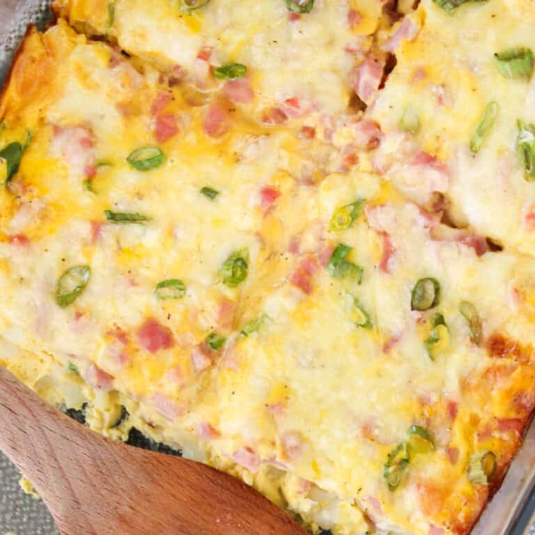 square image of farmer's casserole in baking dish cut into squares