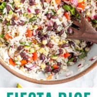 fiesta rice salad in a bowl with a wooden spoon with recipe name at the bottom