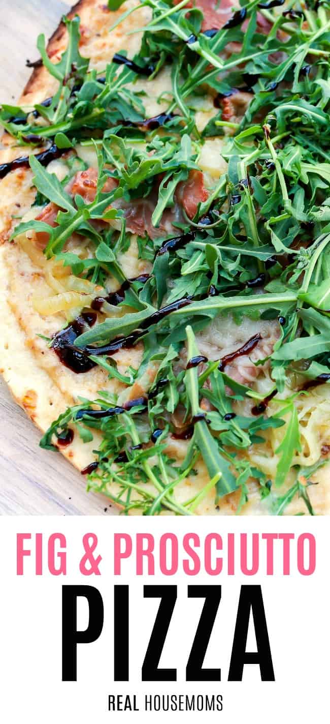 close up of fig & prosciutto pizza toped with arugula