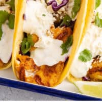 fish tacos in a blue and white serving dish with recipe name at the bottom