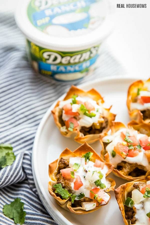 taco cups topped with dean's ranch dip and pico de gallo on a serving platter