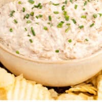 bowl of french onion dip topped with chives with recipe name at the bottom