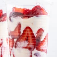 image of three cps of fresas con crema next to some strawberries with the title of thw post on top of the image in red and black lettering