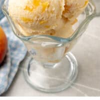 peach ice cream in a dessert cup with recipe name at the bottom