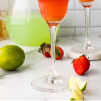 fresh strawberry margarita in a glass with recipe name at the bottom