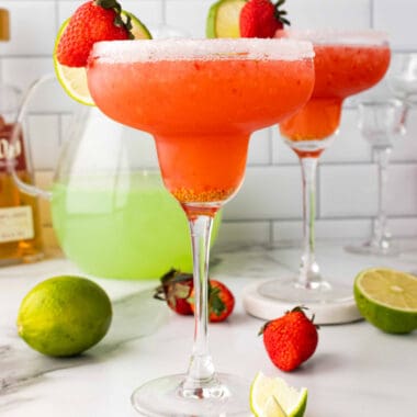 square image of fresh strawberry margaritas with strawberry and lime garnish