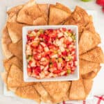 square image of fruit salsa in a bowl surrounded by cinnamon sugar chips