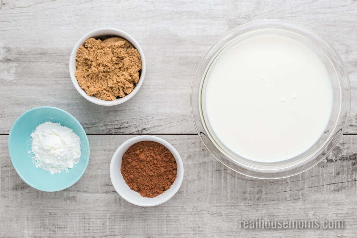 ingredients to make homemaker fudgesicles in bowls on a table