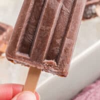 hand holding a fudgesicle with recipe name at the bottom