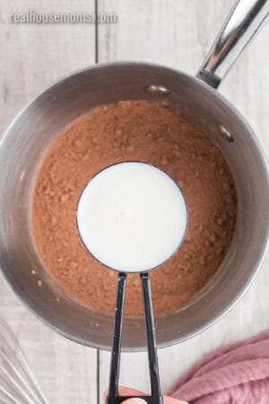1/2 cup milk over a saucepan of cocoa powder, cornstarch, and brown sugar whisked together