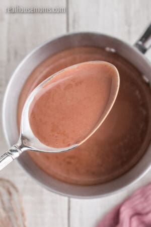 cooked fudgesicle mixture on a spoon showing the consistency