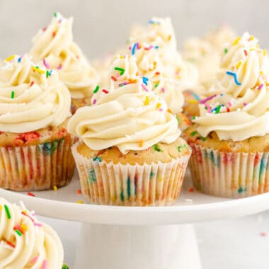 square image of funfetti cupcakes on a cake stand