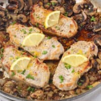 square image of garlic butter pork chops in a skillet