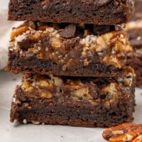 three german chocolate cookie bars stacked up with recipe name at the bottom