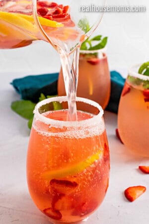 giggle juice being poured into a sugar rimmed glass