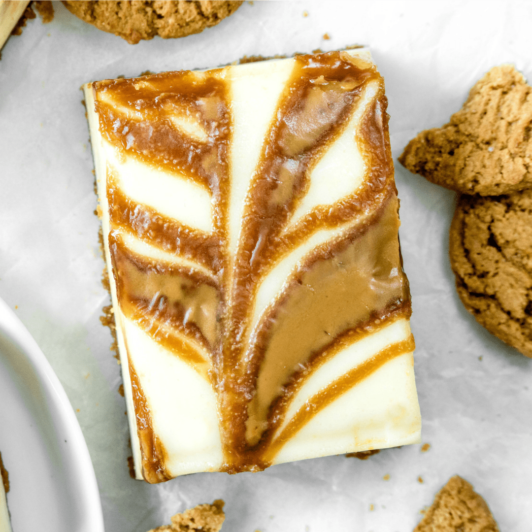 These Gingersnap Cheesecake Bars are an easy Christmas dessert made with a gingersnap crust and swirls of creamy cookie butter!