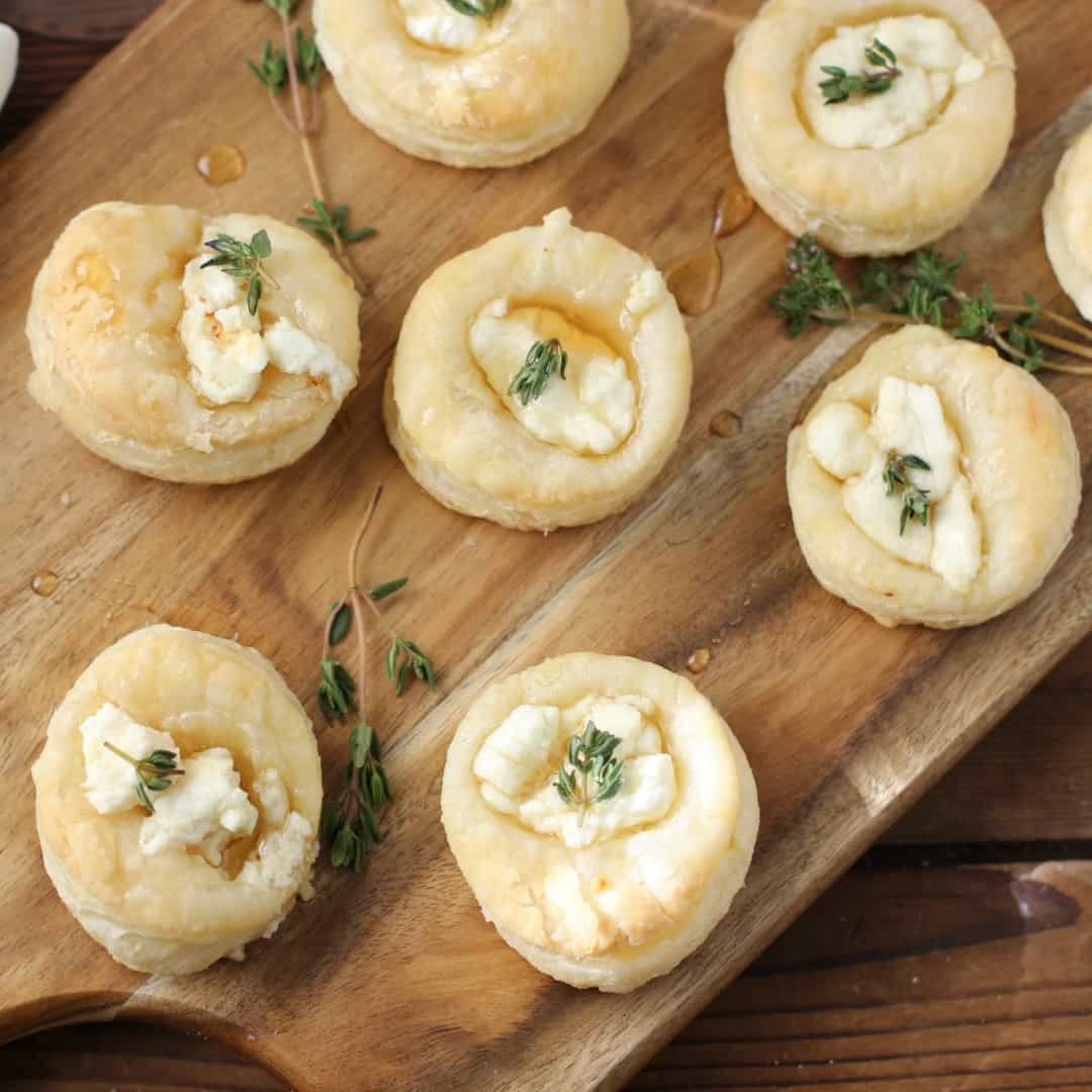 Savory Goat Cheese and Honey Bites are the perfect addition to your next gathering. Flaky pastry topped with creamy goat cheese, sweet honey and thyme make an easy and delicious appetizer!