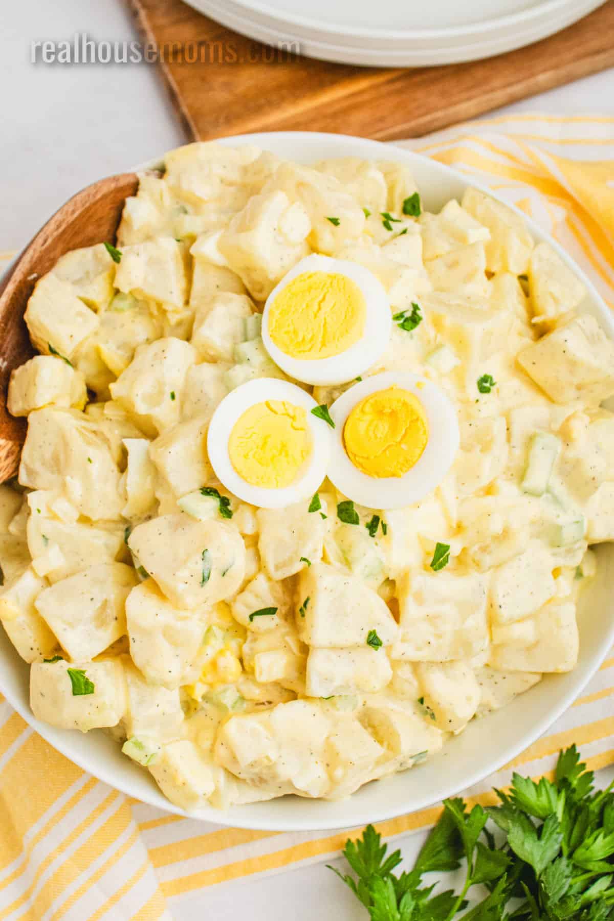 grandma's best potato salad recipe in a serving bowl with egg slices on top for garnish