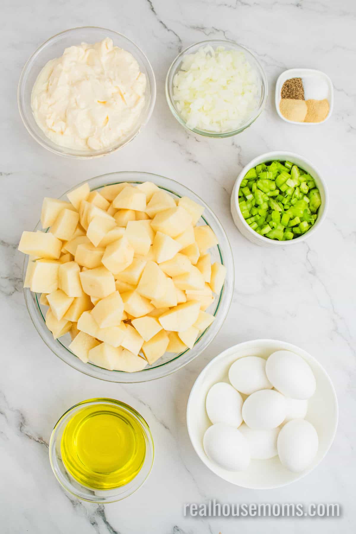 ingredients to make grandma's best potato salad recipe in bowls on a counter