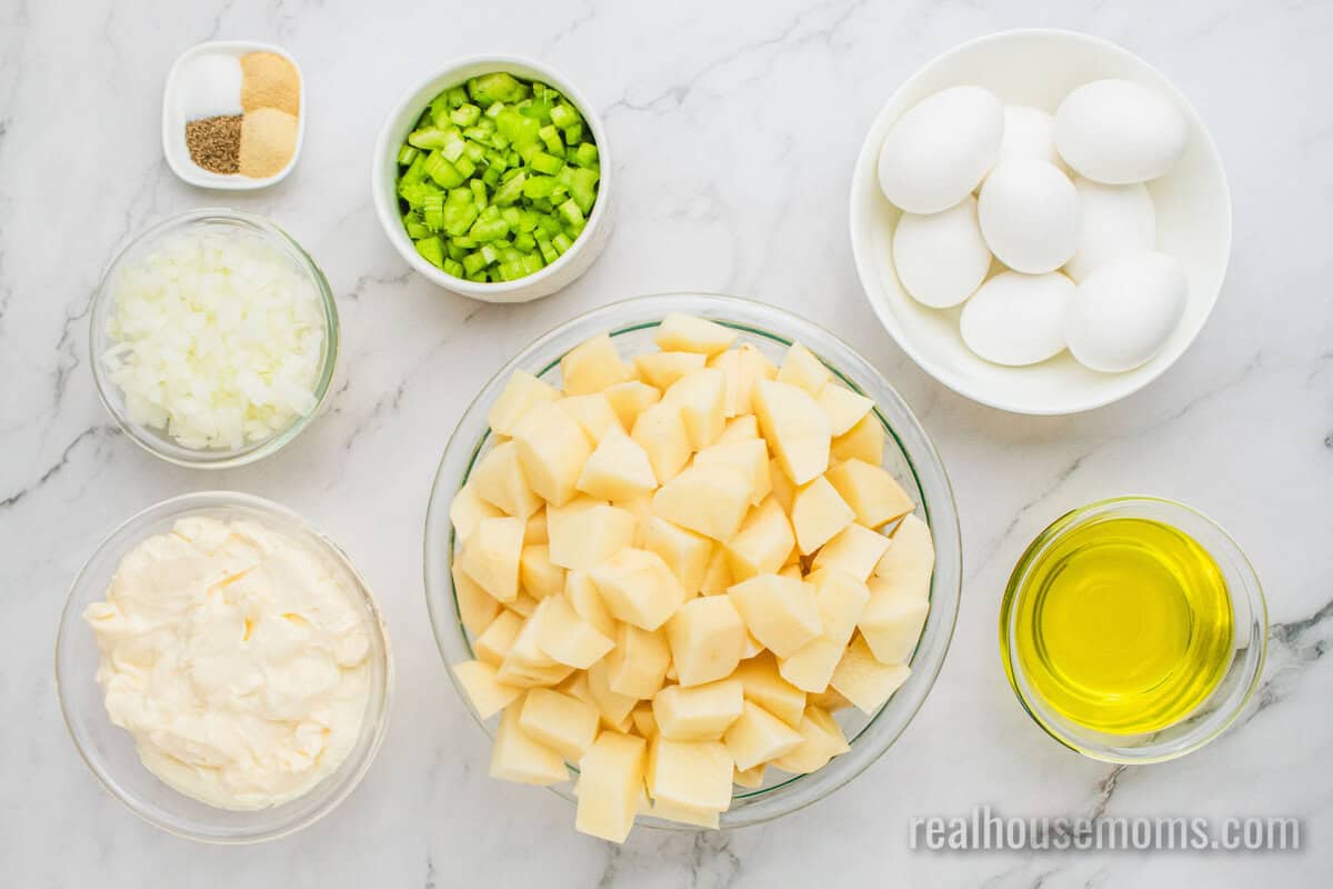 ingredients to make grandma's best potato salad in bowls on a counter