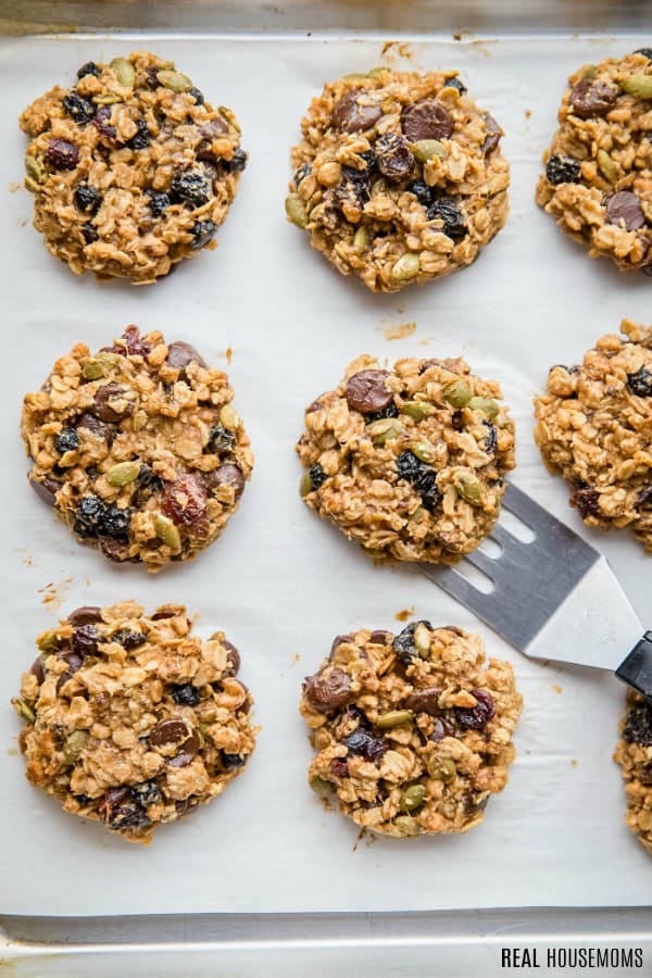 spatula lifting granola breakfast cookies off a baking sheet