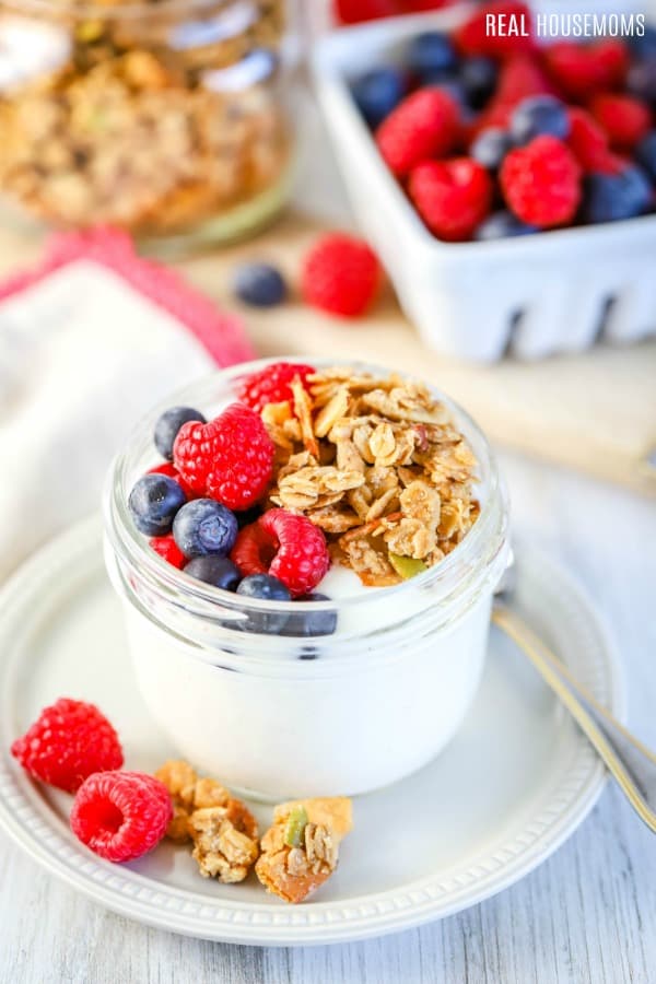 gronal and berries on top of yogurt