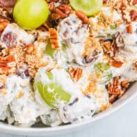 side view of grape salad in a serving bowl with recipe name at the bottom