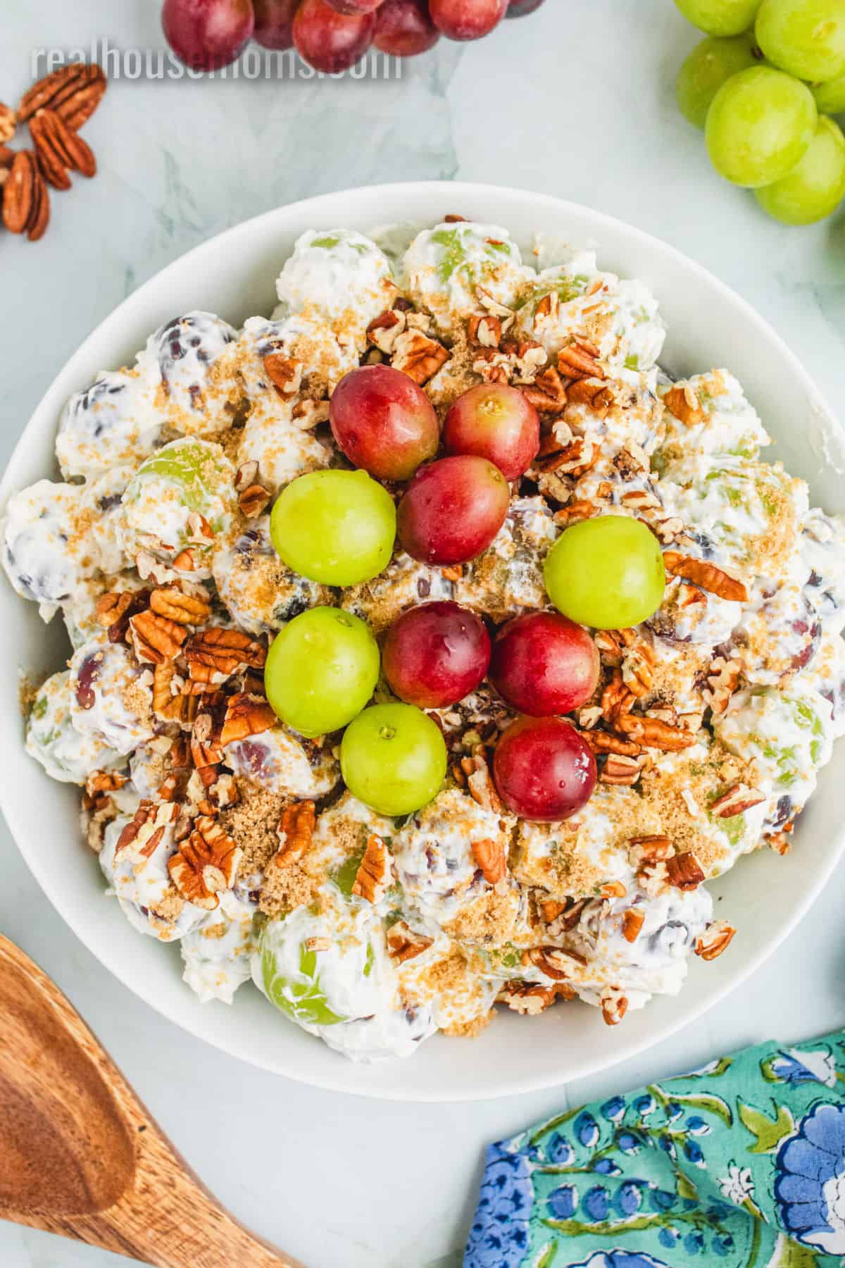 looking down at grape salad topped with brown sugar, pecans, and red and green grapes