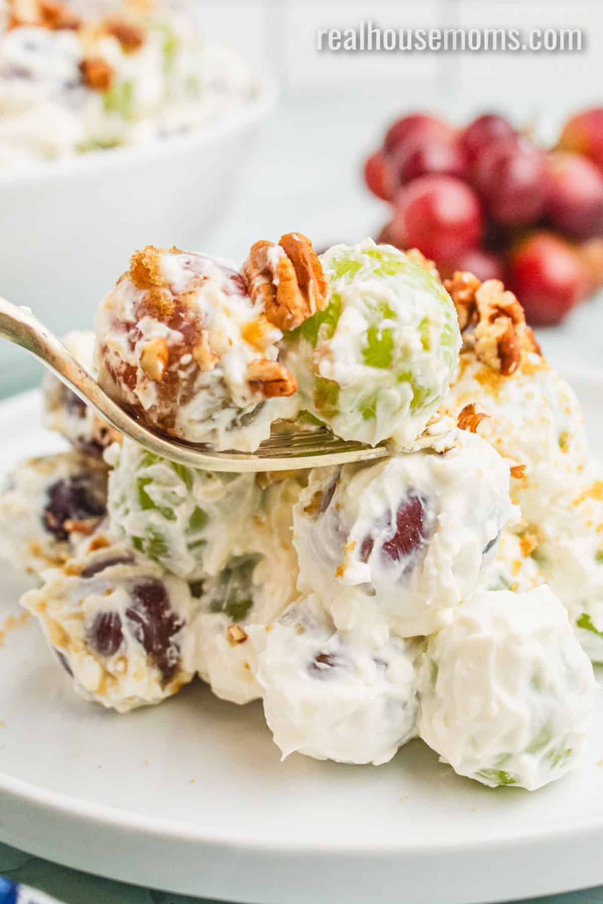 forkful of grape salad over the plate