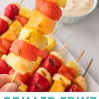 grilled fruit kabobs in front of a bowl of brown sugar dip with recipe name at the bottom
