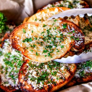 Buttery, thick Italian spiced Grilled Parmesan Garlic Bread is the perfect summer side to almost any meal and so incredibly easy and budget friendly!