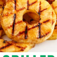 grilled pineapple rings on a platter with recipe name at bottom