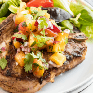 Quick and easy Grilled Pork Chops with Peach Salsa are perfect for summer. Fresh peach salsa elevates these pork chops to company-worthy status!