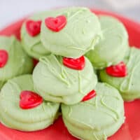 square image of grinch chocolate covered oreos piled up on a red plate